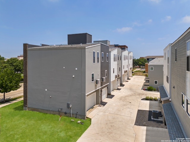 view of property exterior with a yard and cooling unit