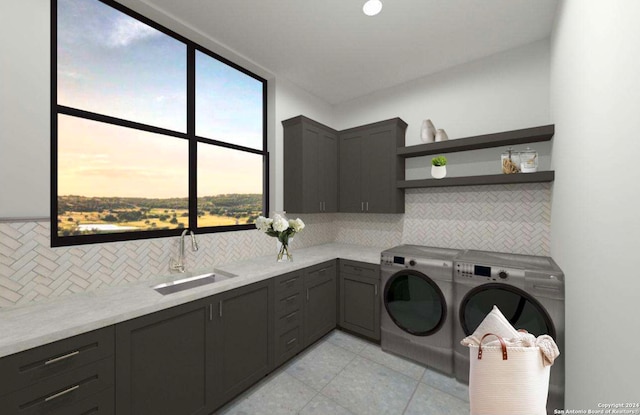 clothes washing area with cabinets, sink, and washer and dryer