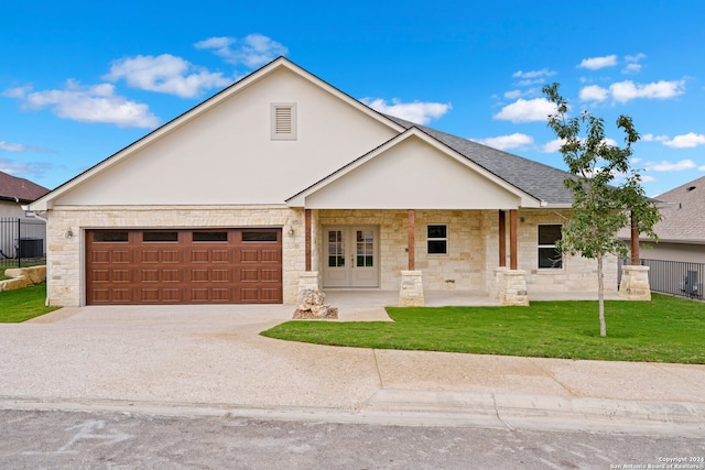 view of front of house featuring a front yard and a garage