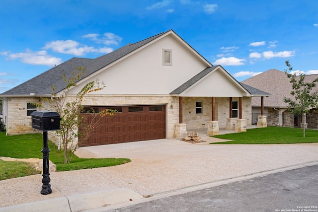 view of front of home with a garage and a front lawn