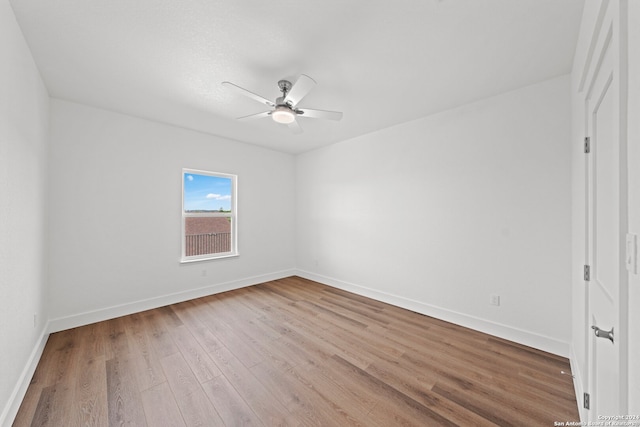 unfurnished room with ceiling fan and light wood-type flooring