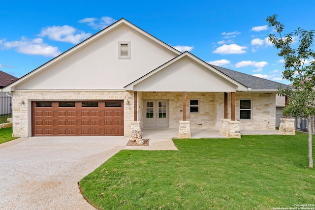 view of front of house with a garage and a front lawn