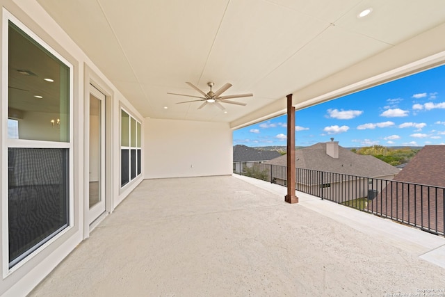 view of patio featuring ceiling fan and a balcony