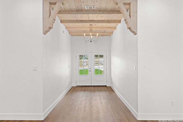 entryway featuring french doors, beamed ceiling, a notable chandelier, wood-type flooring, and wood ceiling