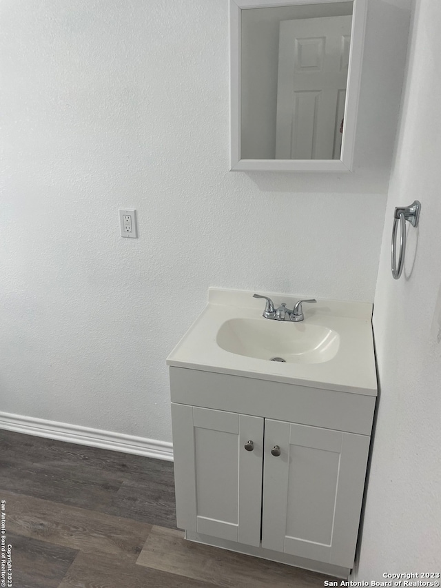 bathroom with vanity and hardwood / wood-style floors