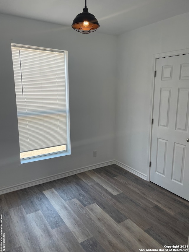 unfurnished room featuring dark hardwood / wood-style flooring