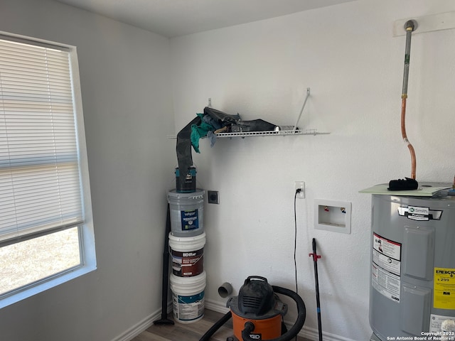 laundry room featuring hookup for an electric dryer, water heater, wood-type flooring, and washer hookup