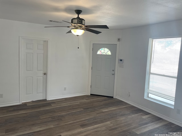 foyer with a textured ceiling, ceiling fan, and dark hardwood / wood-style flooring