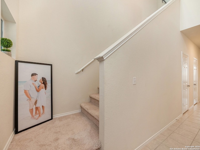 stairs with tile patterned floors