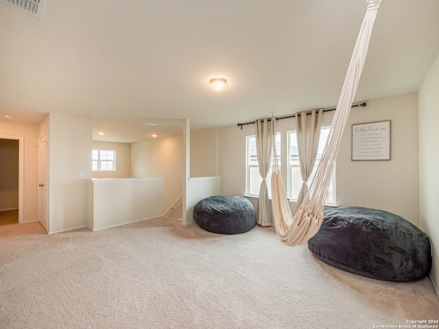 sitting room featuring a healthy amount of sunlight and carpet