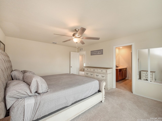 carpeted bedroom with connected bathroom and ceiling fan