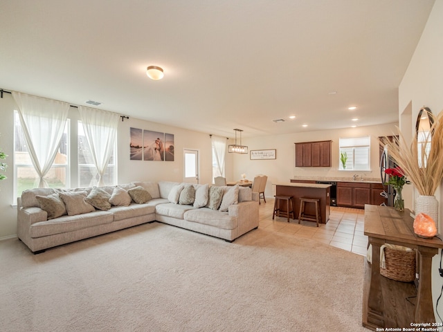 tiled living room with sink and a healthy amount of sunlight