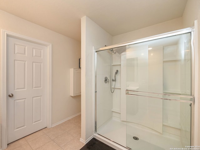 bathroom featuring an enclosed shower and tile patterned floors