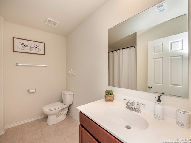 bathroom featuring vanity, toilet, and tile patterned floors