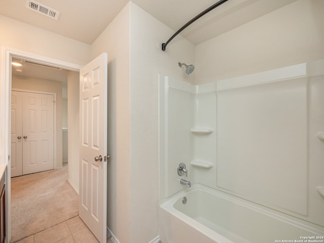 bathroom with tile patterned flooring and shower / bathtub combination