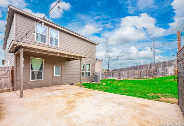 rear view of property featuring a yard and a patio area