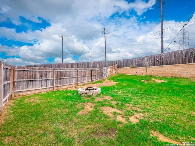 view of yard with an outdoor fire pit