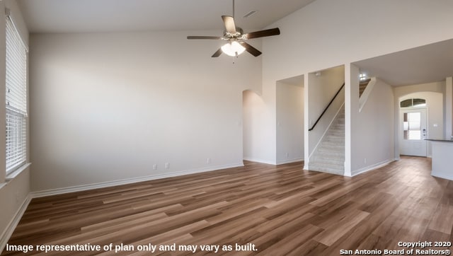 unfurnished room featuring high vaulted ceiling, dark wood-type flooring, and ceiling fan