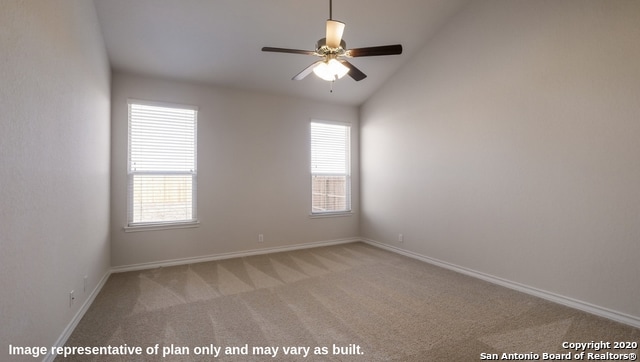 spare room featuring lofted ceiling, light colored carpet, and ceiling fan