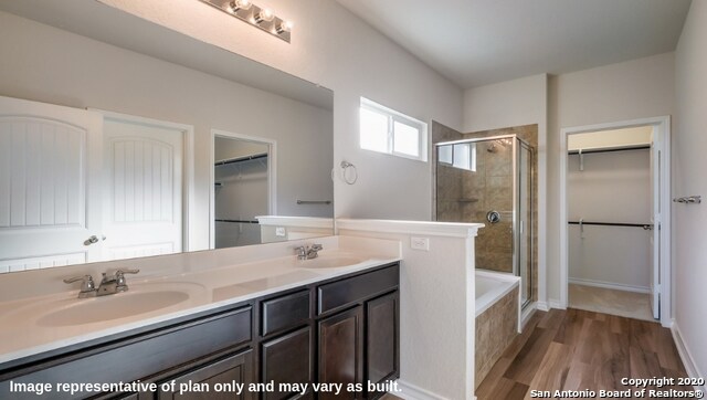 bathroom with vanity, wood-type flooring, and separate shower and tub