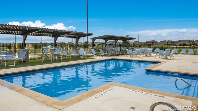 view of pool featuring a patio and a pergola