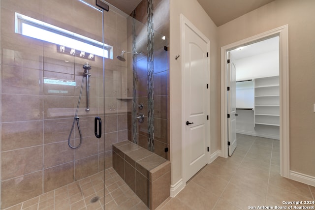 bathroom featuring tile patterned floors and a shower with shower door