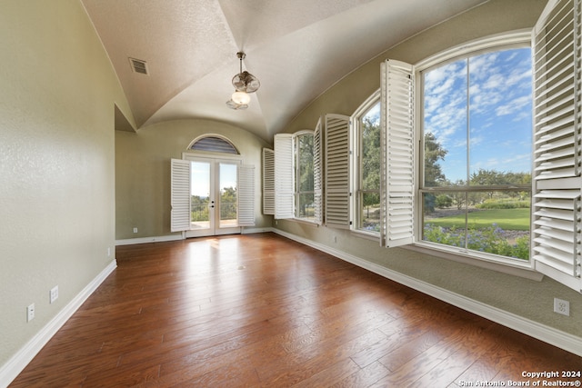 spare room featuring french doors, vaulted ceiling, and dark hardwood / wood-style floors