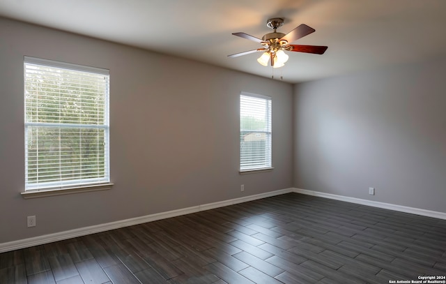 spare room featuring dark wood-type flooring and ceiling fan