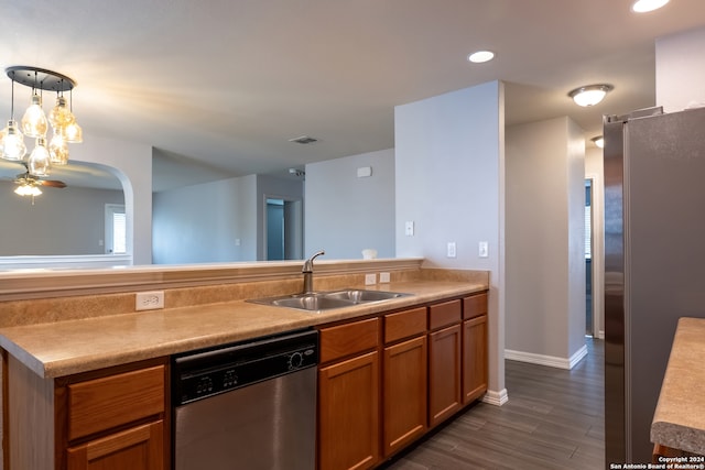 kitchen featuring ceiling fan, dark wood-type flooring, sink, pendant lighting, and stainless steel appliances