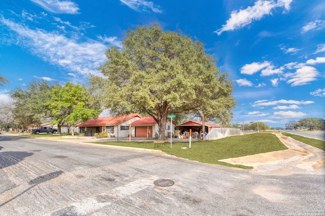 view of front of home with a front lawn and a garage