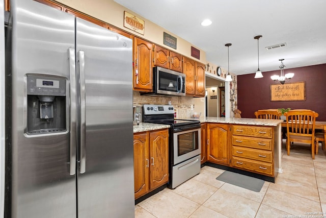 kitchen featuring tasteful backsplash, kitchen peninsula, stainless steel appliances, pendant lighting, and a notable chandelier