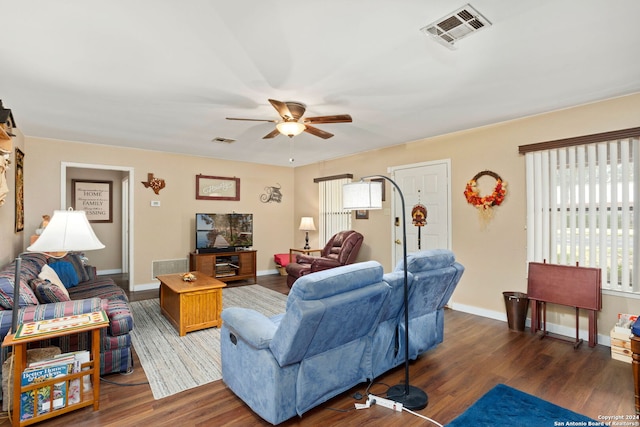 living room featuring ceiling fan and dark hardwood / wood-style floors