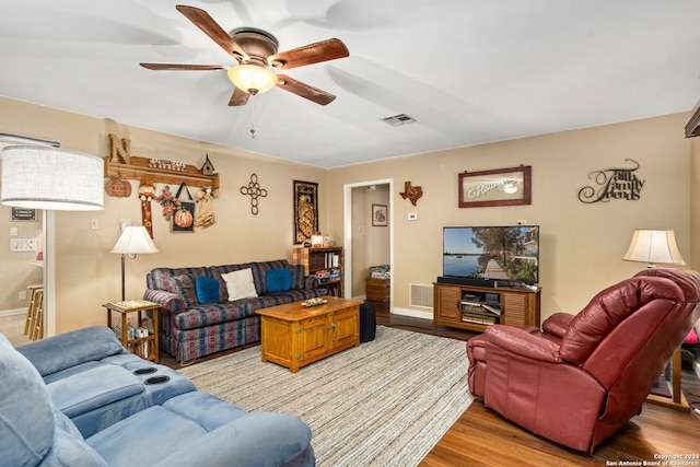 living room featuring light hardwood / wood-style flooring and ceiling fan