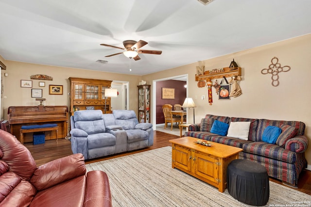 living room featuring light hardwood / wood-style flooring and ceiling fan