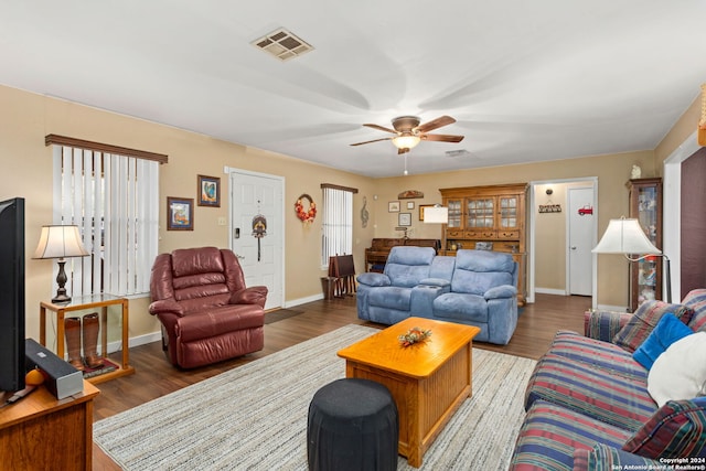 living room with wood-type flooring and ceiling fan