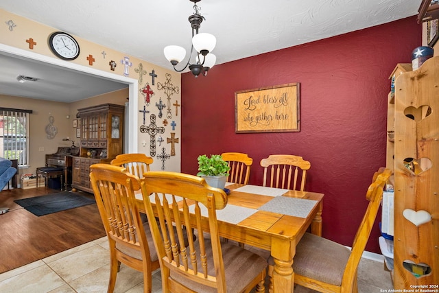 dining room featuring light hardwood / wood-style flooring and a notable chandelier