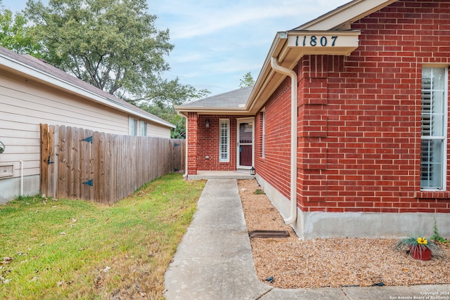 entrance to property with a lawn