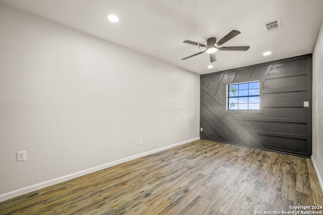 spare room with ceiling fan and hardwood / wood-style flooring