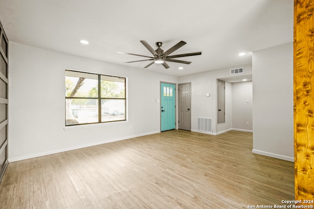 unfurnished living room with ceiling fan and light wood-type flooring