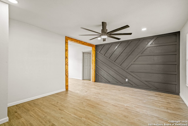 spare room with ceiling fan and light hardwood / wood-style floors