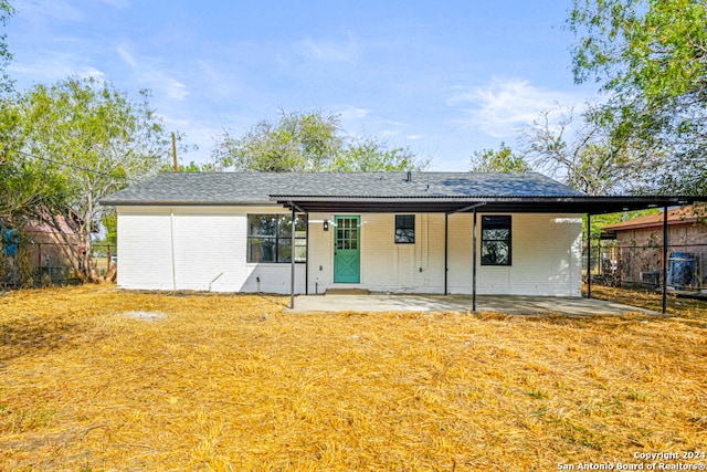 rear view of property featuring a lawn and a patio