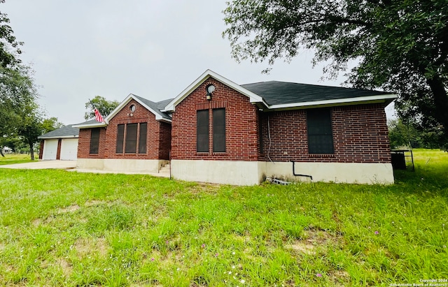 view of property exterior featuring a yard and a garage