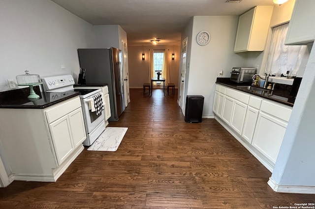 kitchen featuring dark hardwood / wood-style flooring, white cabinetry, sink, and electric stove