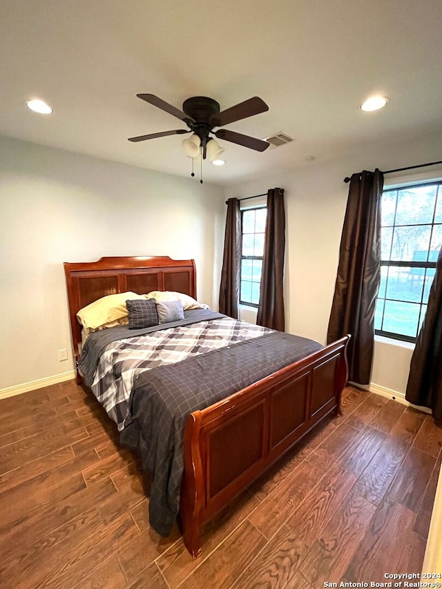 bedroom with ceiling fan and dark hardwood / wood-style flooring