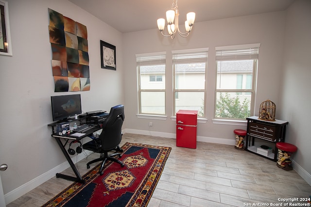 home office featuring hardwood / wood-style floors, an inviting chandelier, and a wealth of natural light