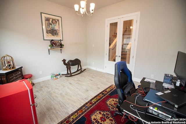 office space featuring hardwood / wood-style flooring, a notable chandelier, and french doors