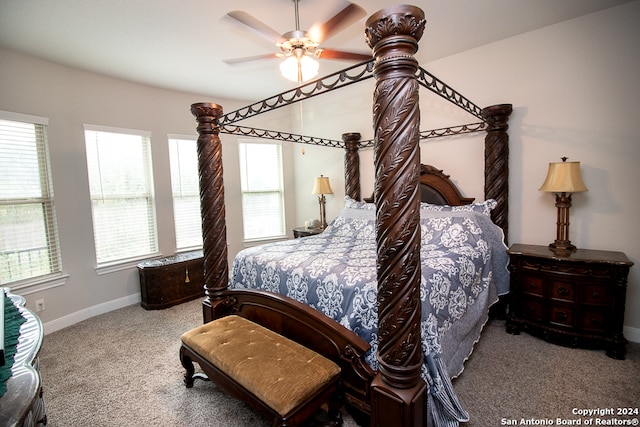 carpeted bedroom with ceiling fan and multiple windows