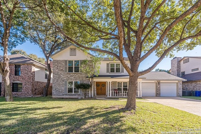 view of front of property featuring a porch, a garage, and a front yard