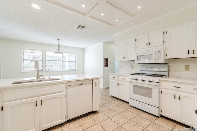 kitchen featuring white appliances, hanging light fixtures, white cabinetry, and sink