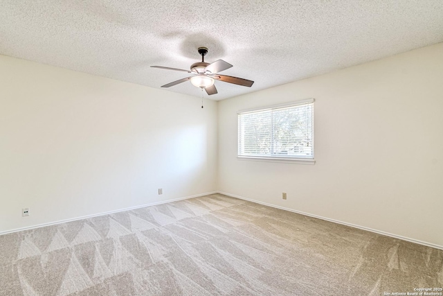 carpeted spare room with a textured ceiling and ceiling fan